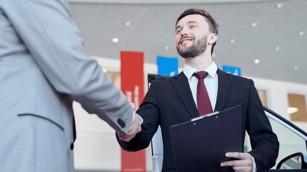 Business owner shaking hands with a potential buyer."